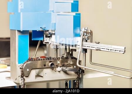 Professional industrial machine with a blue body for sharpening chainsaw chains. Close-up. Copy space. Stock Photo