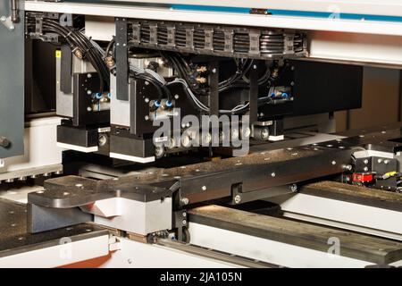 A fragment of an electronic thickness gauge mechanism with precise positioning of machined parts of an automatic woodworking machine. Stock Photo