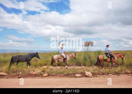Gauchos on horseback on the road to the 'Altas Cumbres', Cordoba, Argentina. Stock Photo