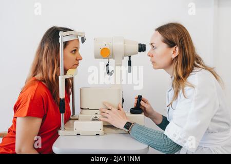 Eye test for visual acuity. The patient receives eye consultation. Stock Photo