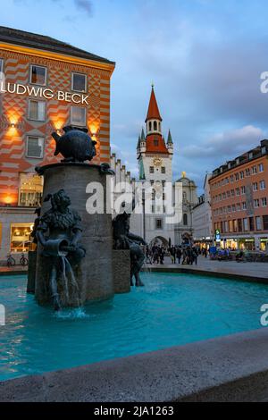 Munich, Germany - 04.07.2022: fischbrunnen in Marienplatz Munich with people and the altes Rathaus Stock Photo
