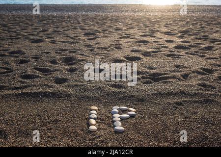 IP Intellectual Property or Internet protocol text made from stones on sea beach Stock Photo