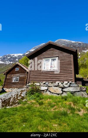 Traditional grass roofed wooden farm cabins on the shore of Lake Lovatnet, Breng Seter. Norway Stock Photo