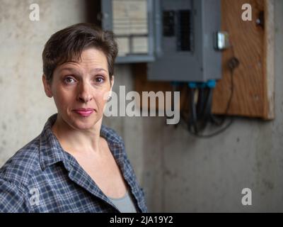 Female Electrician  check or Inspect Electrical Outlet. Diversity in the workforce concept. Stock Photo