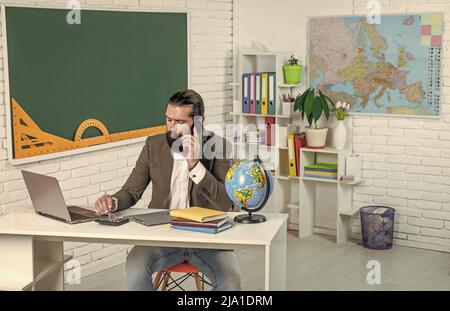 formal education. knowledge day. mature bearded teacher at lesson. brutal man work in classroom with blackboard. prepare for exam. college lecturer on Stock Photo