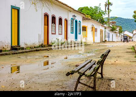 Dirt street wet by rain and colonial-style houses in the old and historic city of Paraty Stock Photo