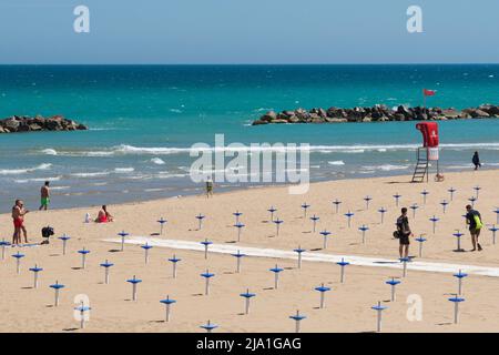 Termoli (CB),Molise Region,Italy:North promenade of Termoli with still few people on the beach at the end of May 2022, at the beginning of the bathing Stock Photo