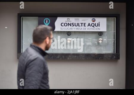 A person stands in front of a information window set for the Presidential Elections in Bogota, Colombia May 26, 2022. Presidential elections will take place on May 29. Photo by: Camilo Erasso/Long Visual Press Stock Photo