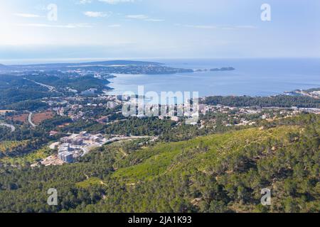 Aerial view of Peguera from mountain side with hotels and beaches. Sea in background. Mallorca, Balearic Islands, Spain Stock Photo