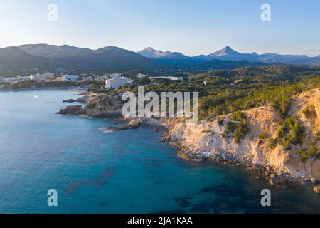 Aerial view of Peguera from sea side with hotels and beaches. Mountains in background. Mallorca, Balearic Islands, Spain Stock Photo