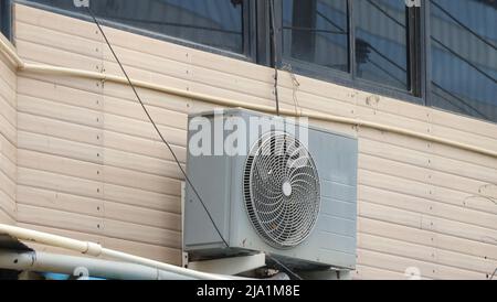 Air condition unit compressor or condensing unit installed outside building wall.Concept showing appliance for office and house Stock Photo