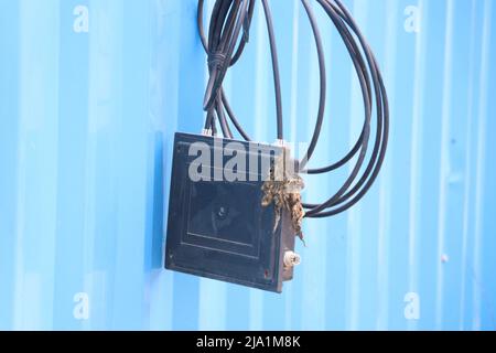 Reels of fiber optic cable with splitter box for high speed internet communication hanging Stock Photo