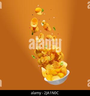 Potato chips falling onto plate on white background. Advertising concept. Levitation flying chips Stock Photo