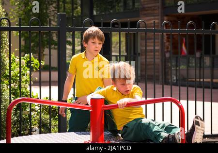 Two boy brothers (4-5, 8-9) playing on playground Stock Photo
