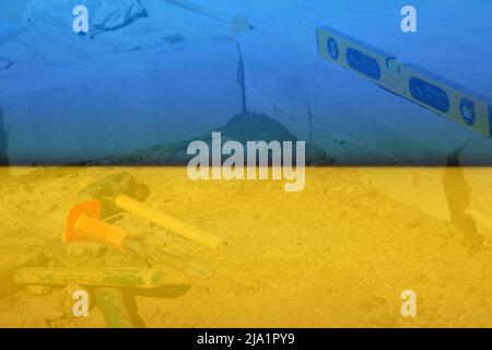 Defocus Paving garden. Yellow spirit level, hammer, mallet, chisel lie on the ground. Set of tools for laying paving stones. Cement curbs. Garden Bric Stock Photo