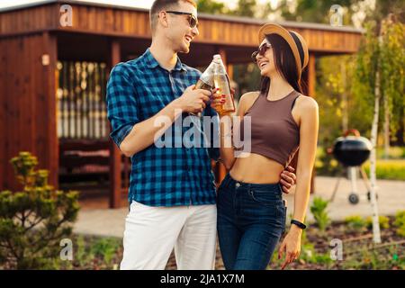 group of friends hang out on the street. They hug each other and walk in the park at sunset. Drinking cold juice.Group of friends walking in the city Stock Photo