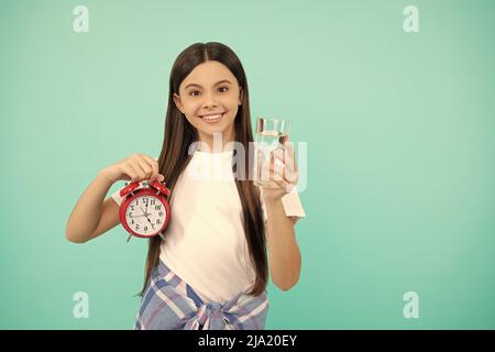 hydration vitality. drinking per day. be hydrated. kid hold glass and clock. child feel thirsty. Stock Photo