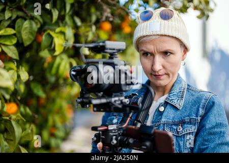 Camera operator with movie setup including a gimbal, video transmitter and wireless microphone Stock Photo