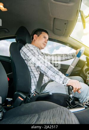 Interior view of a young man driving a car, A happy man driving a car, Side view of a man driving a car, concept of man brand new car Stock Photo