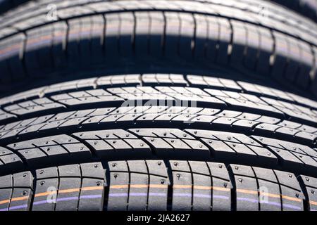 new car summer tires in a row. Car tire tread close-up. Stock Photo
