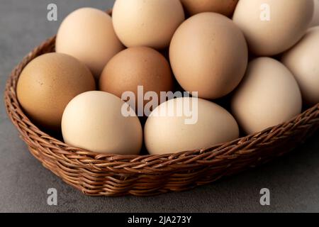 Farm chicken eggs. Lots of eggs in a wicker basket close up. Stock Photo