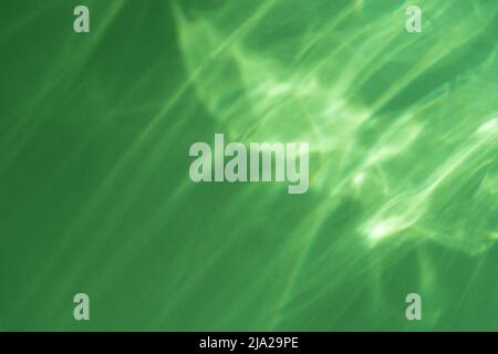Caustic effect light refraction on green wall overlay photo mockup, blurred sun rays refracting through glass prism with shadow. Abstract natural Stock Photo