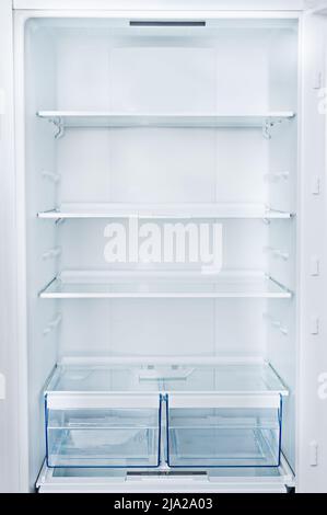 Empty Refrigerator with door open.Vertical photo and copy space Stock Photo