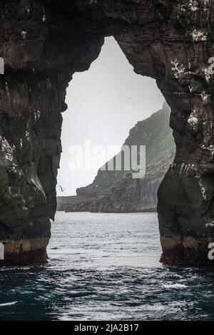 The arch of Stori Drangur seen from a boat, Vagar, Faroe Islands Stock Photo
