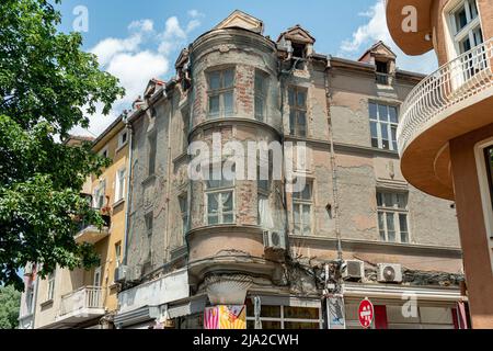 Plovdiv, Bulgaria - 23.05.2022: Historical building facade under renovation works covered with protective net for safety Stock Photo