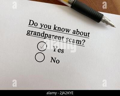 One person is answering question about scam and fraud. He knows about grandparent scam. Stock Photo
