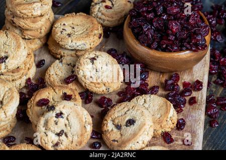 round wheat cookies with dried cranberries, delicious dried cookies made of high-quality flour with dried red cranberries on the table