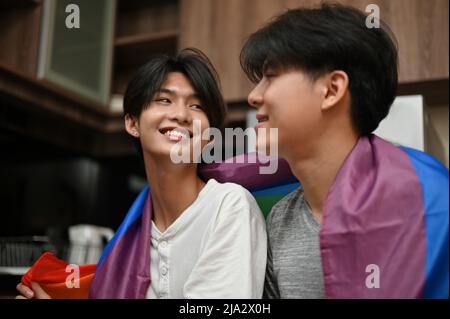 LGBT couples concept, Asian teenage gay men's couple face to face, sharing a special romantic love feeling for each other in the kitchen. Stock Photo