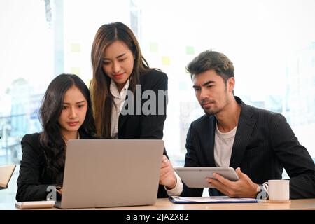 A business financial analysts team brainstorming and discussing the financial investment plan in the office. Stock Photo