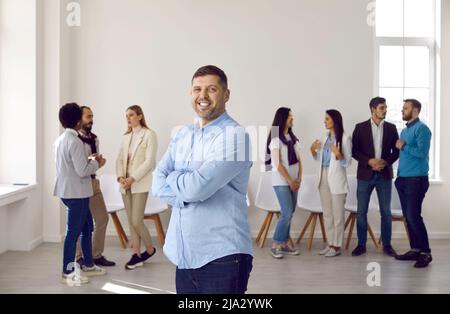 Portrait of smiling businessman posing in office Stock Photo