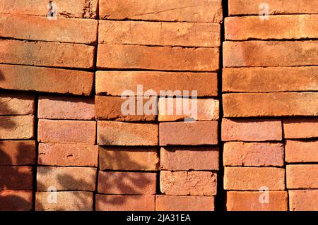 Pile of red bricks texture pattern background Stock Photo