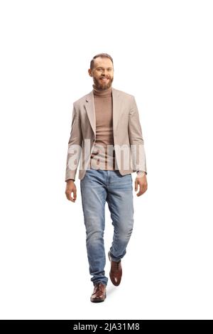 Fair haired young man walking towards camera and smiling isolated on white background Stock Photo