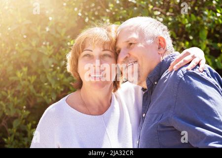 Retired Senior Couple Together In Green Outside Stock Photo