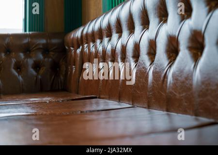 old brown leather sofa, indoor contra-light shot Stock Photo