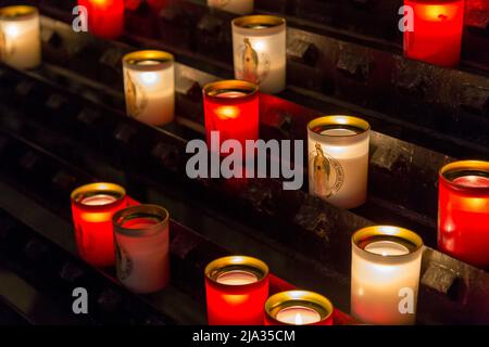 Paris, France, March 27 2017: Rows of firing lit votive candles inside Notre Dame de Paris, France. Stock Photo