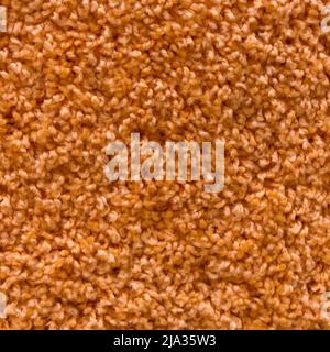 Carpet texture. Orange carpet background close up. Stock Photo