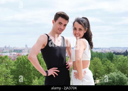 Portrait of a young sporty couple smiling and looking at camera. Stock Photo
