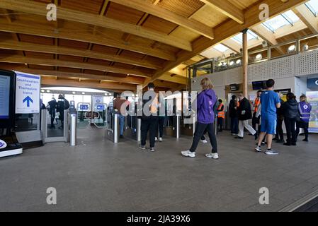 Passengers entering the ticket barrier at the new Abbey Wood Crossrail Elizabeth Line Station on opening day, 24th May 2022 Stock Photo