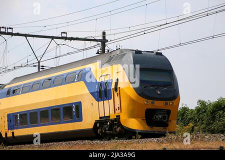 Double decker intercity train on the track at Moordrecht heading to Gouda in the Netherlands. Stock Photo