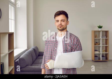 Man with broken arm is rehabilitated with help of medical devices to support his arm. Stock Photo