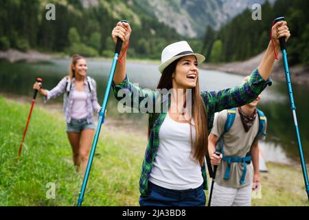 Group of fit healthy friends trekking in the mountains Stock Photo