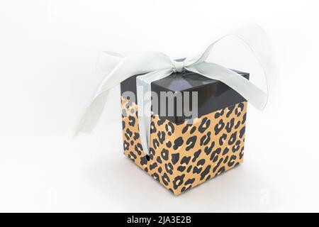 Holiday gift box or present with silver colored bow ribbon against white background Stock Photo