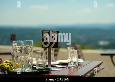 Königswinter, Germany- May 18, 2022 : A table with empty beer glasses at the famous outdoor terrace of Drachenfels Stock Photo