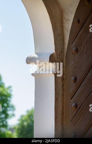 Fragment of a heavy arched door. Stock Photo