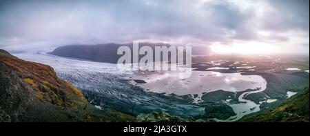 Spectacular wide panorama to massive glacier with clouds and ray lights Stock Photo