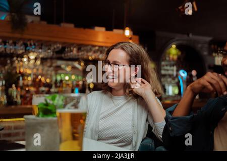 diverse work friends out for dinner laughing  Stock Photo